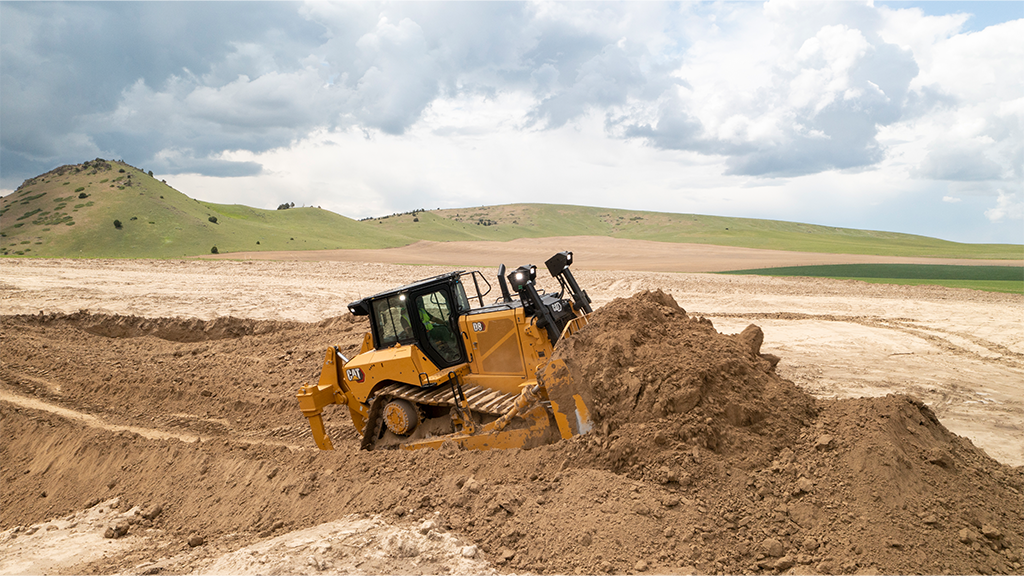 A bulldozer pushing a large mound of soil