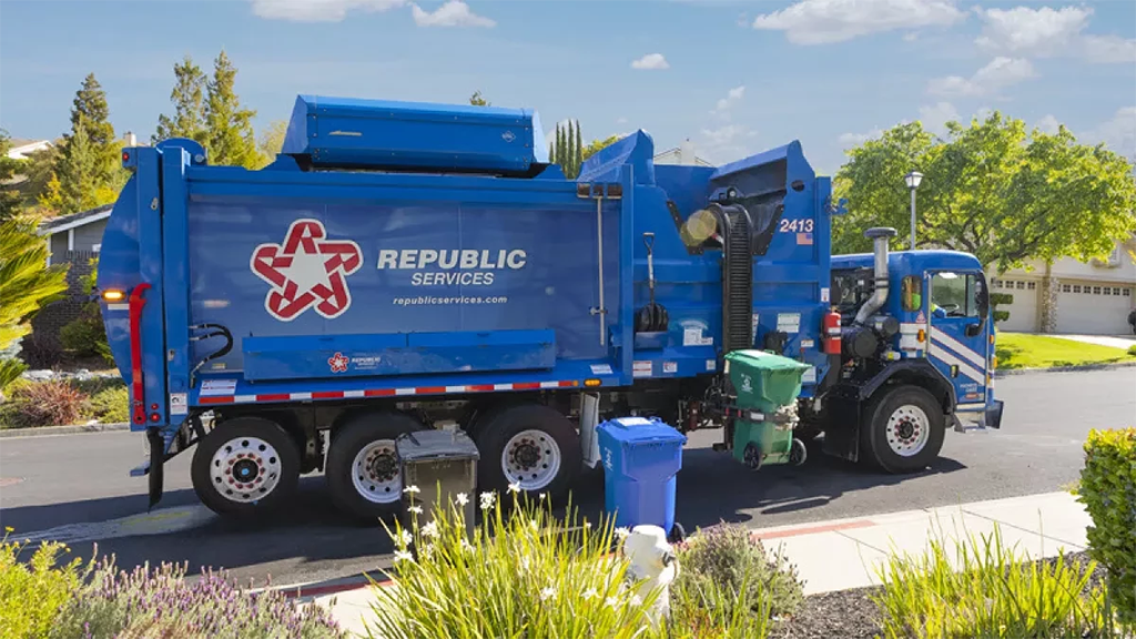 A refuse vehicle picks up a curbside bin
