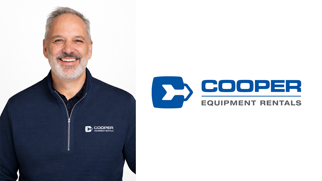 A man poses for a photo next to the Cooper Equipment Rentals logo