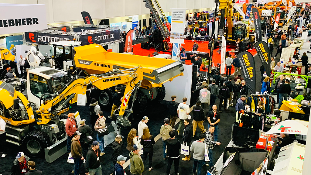 An aerial view of a trade show floor with people and heavy equipment An aerial view of a trade show floor with people and heavy equipment