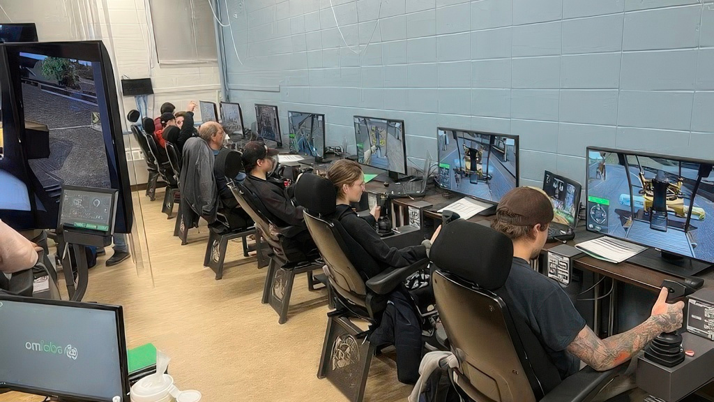 A group of students sitting at simulation-based training monitors