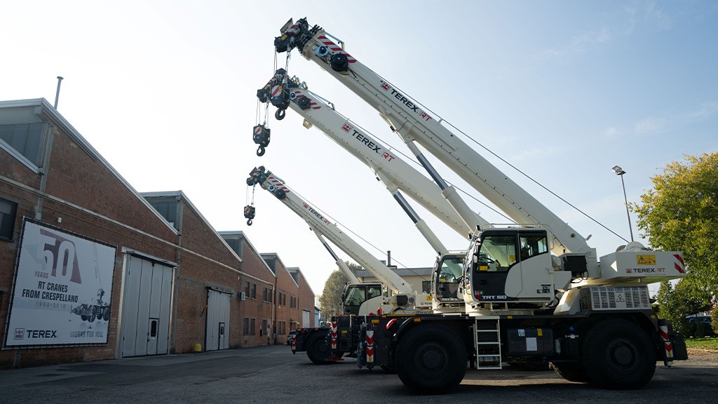 Several rough terrain cranes in a row