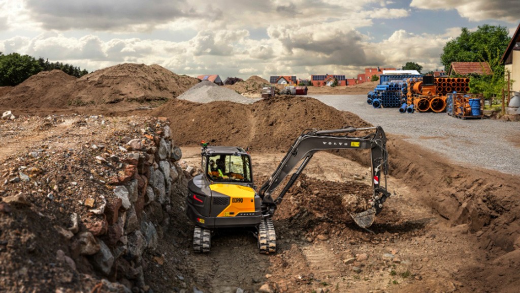A short-swing compact excavator at an outdoor construction site