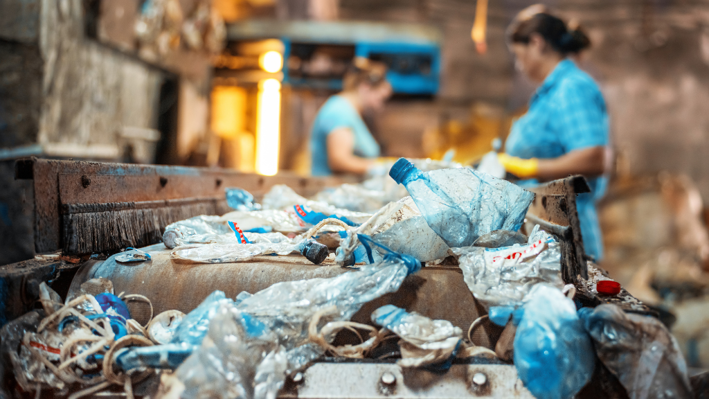 Two women work on a soft and flexible plastics conveyor belt