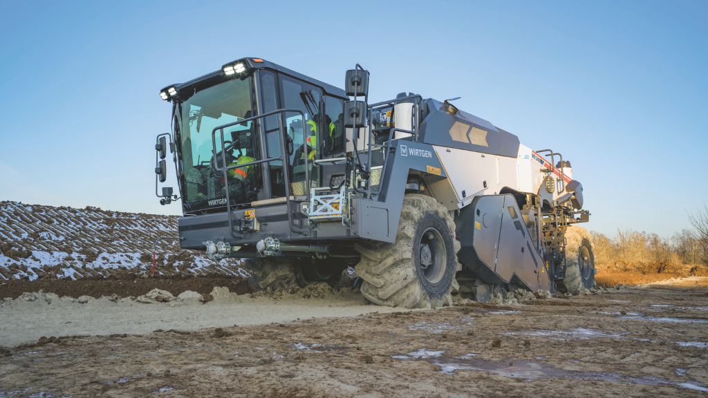 A wheeled cold recycler working on an unpaved road A wheeled cold recycler working on an unpaved road