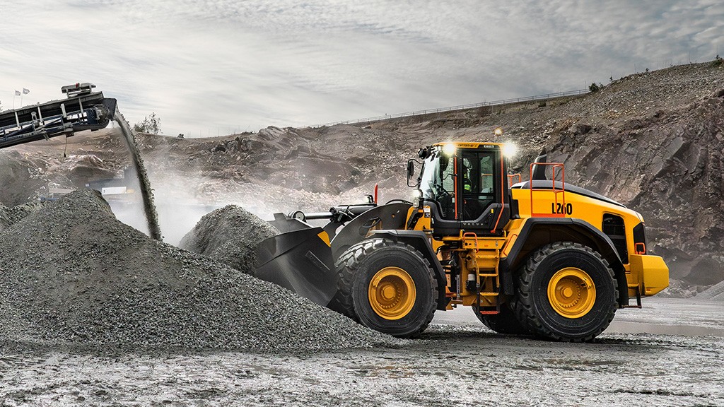 A large wheel loader pushes its bucket into a pile of aggregates A large wheel loader pushes its bucket into a pile of aggregates