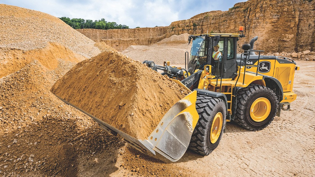 A wheel loader holds a bucket filled with aggregates A wheel loader holds a bucket filled with aggregates