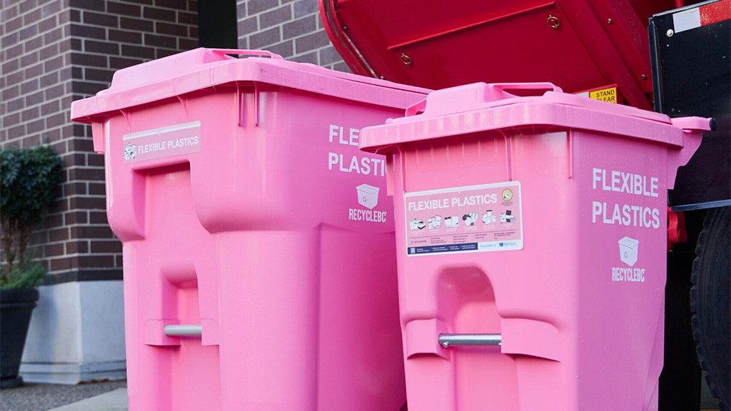 Two hot pink recycling bins