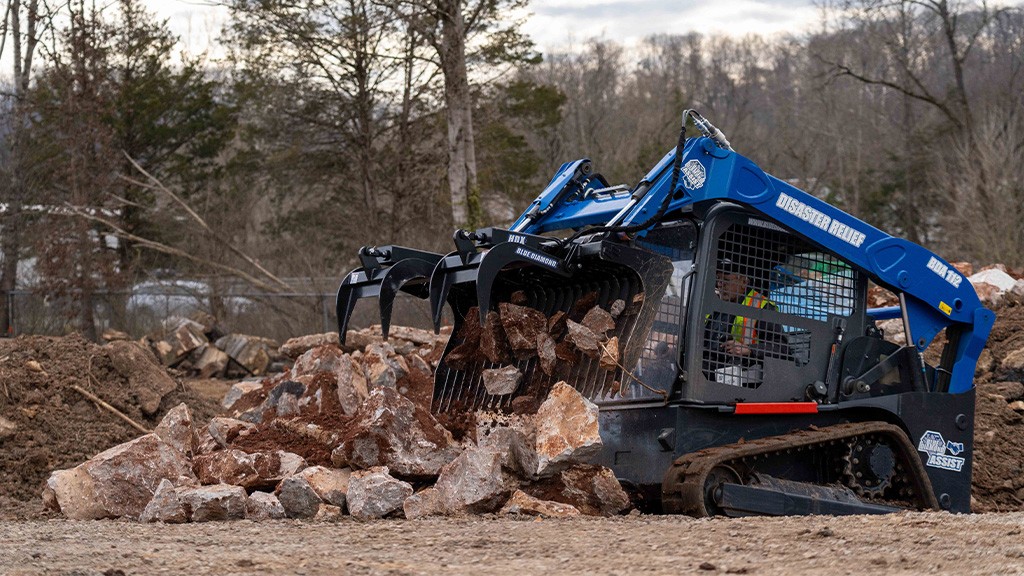 A skid-steer loaded fitted with a rock grapple attachment