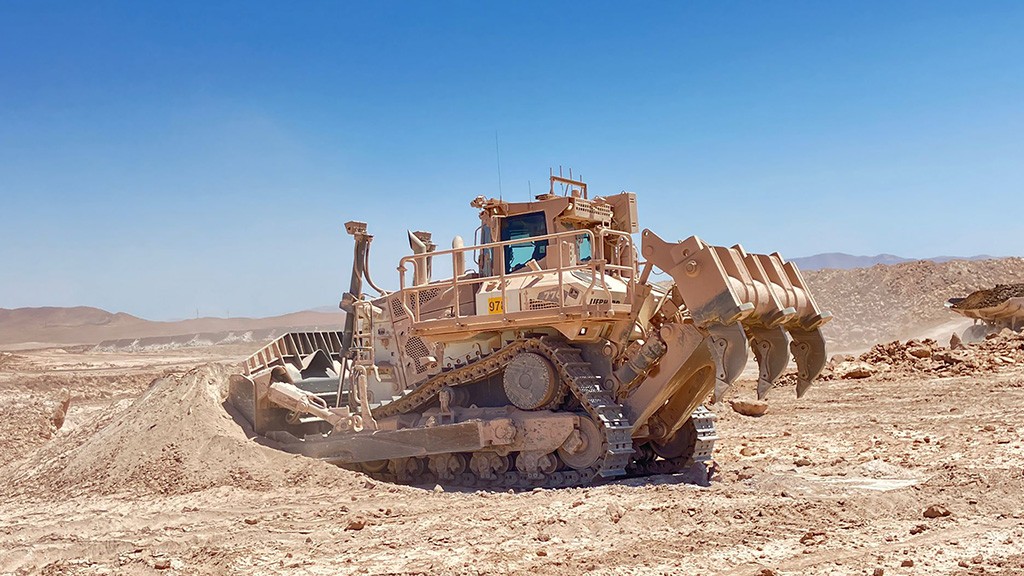 A large mining dozer fitted with a ripping attachment