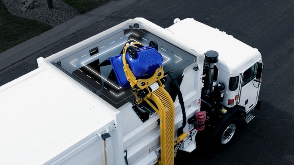 A refuse truck dumps a household bin into its hopper