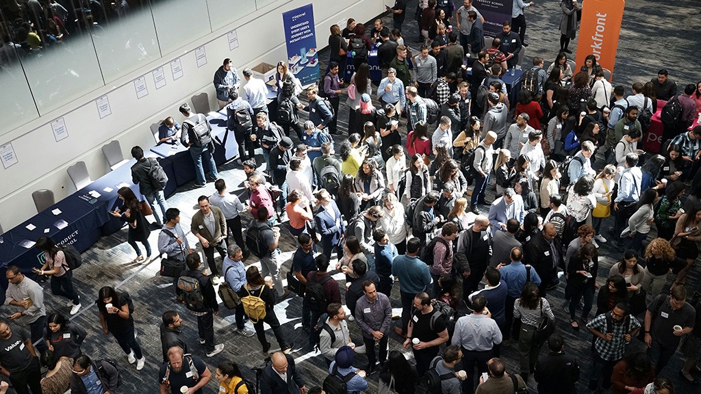 An aerial view of a large crowd at a trade show
