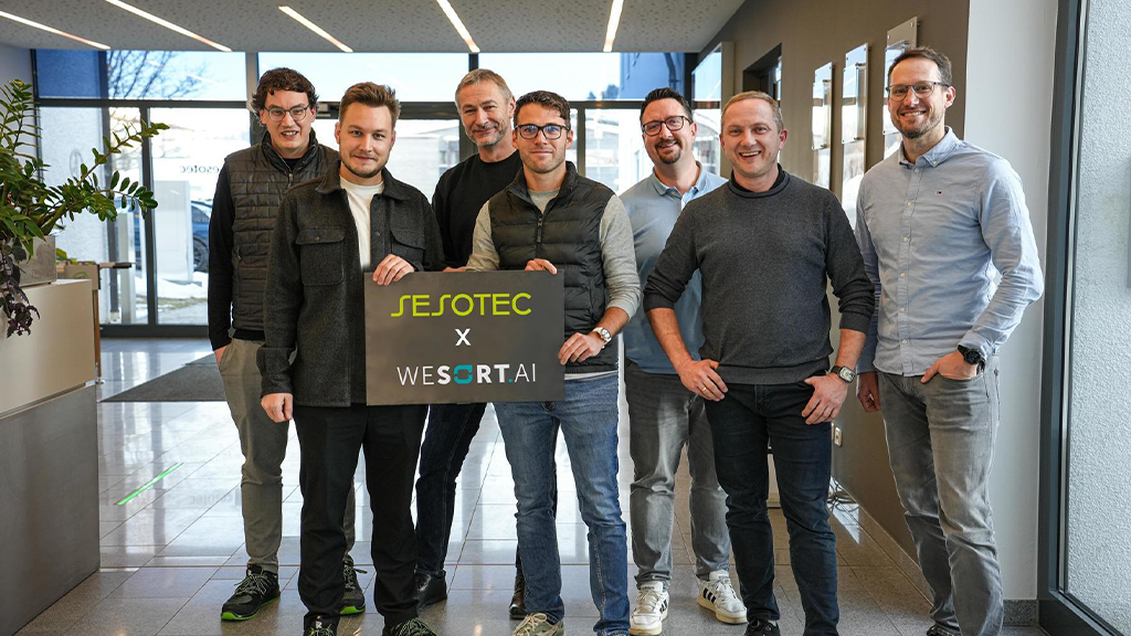 A group of men pose for a photo