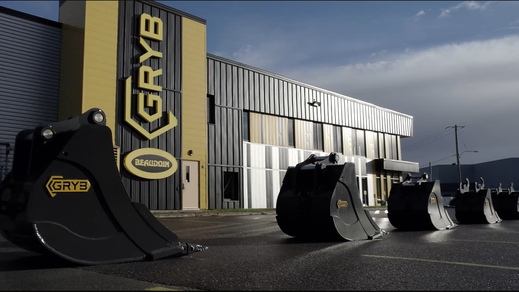 Several bucket attachments in front of the GRYB headquarters