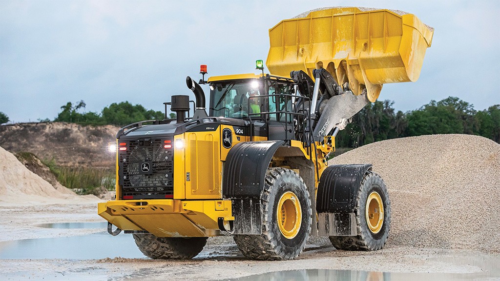 A yellow wheel loader with its bucket attachment raised A yellow wheel loader with its bucket attachment raised