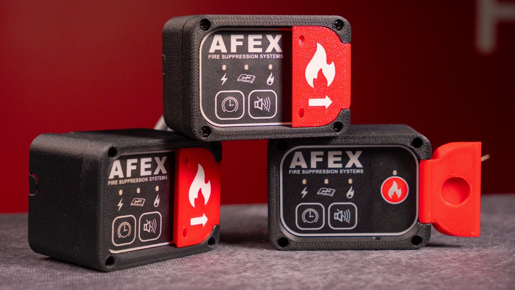 Three small black and red fire suppression systems Three small black and red fire suppression systems
