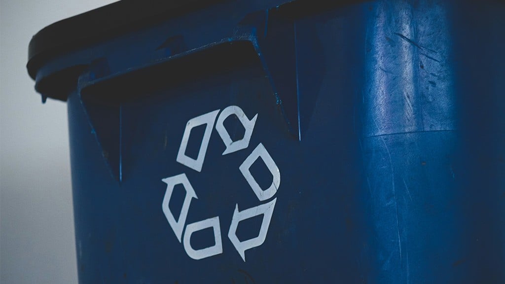 The side of a blue recycling bin