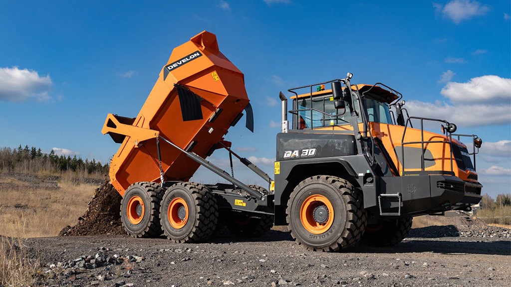 An articulated hauler dumps soil An articulated hauler dumps soil