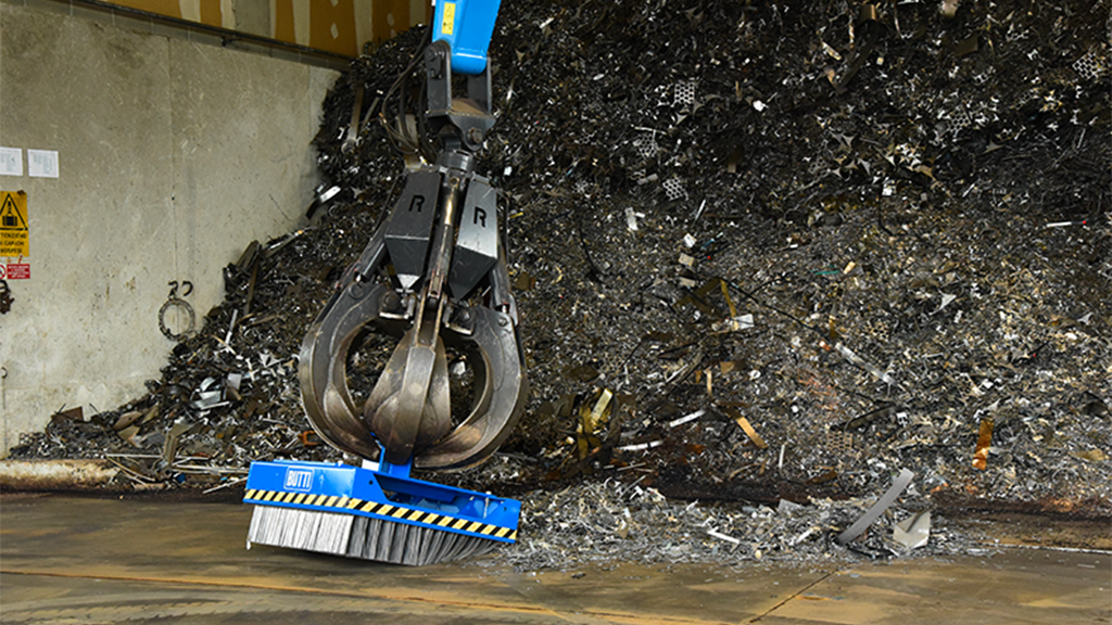 A mushroom brook attached to a material handler cleaning up a recycling facility
