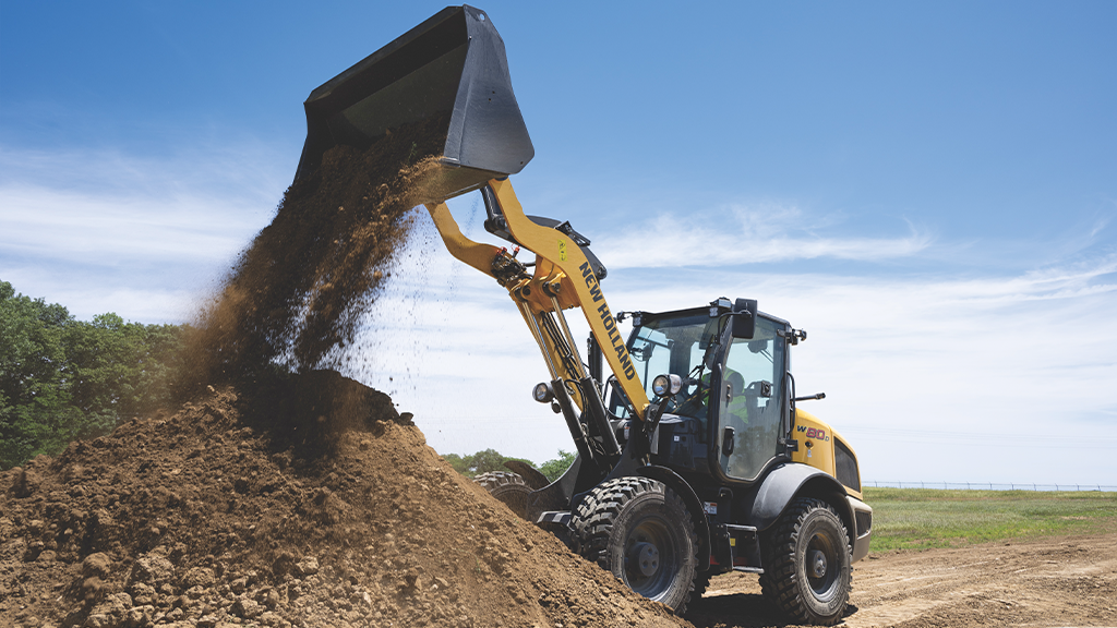 A long-reach compact wheel loader with its bucket attachment raised A long-reach compact wheel loader with its bucket attachment raised