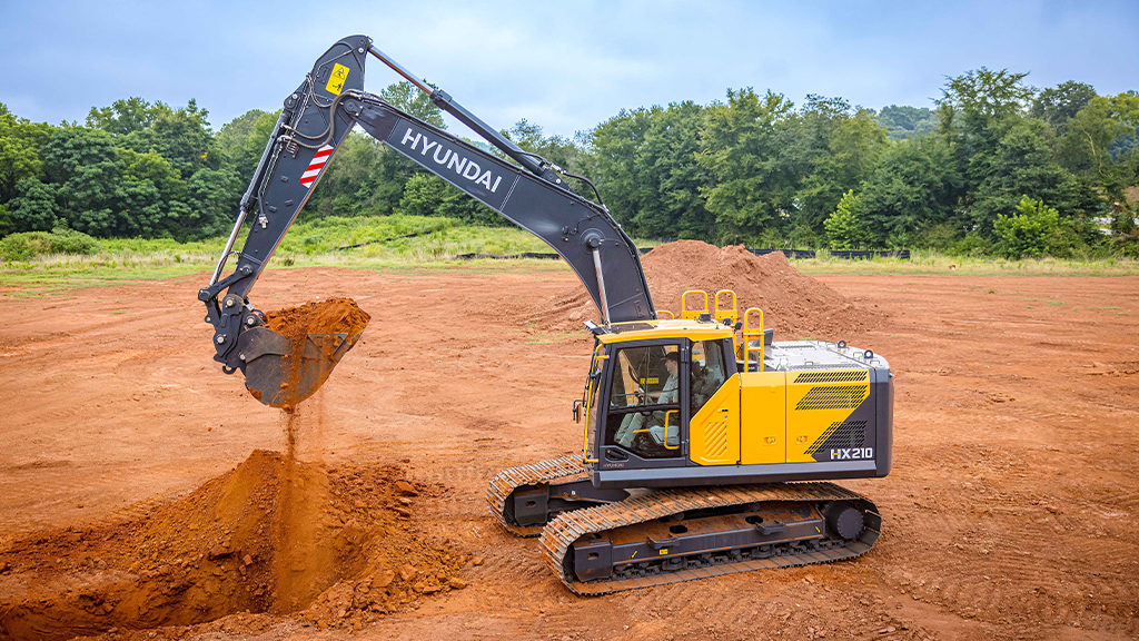 An excavator lifts a pile of soil on an outdoor site An excavator lifts a pile of soil on an outdoor site