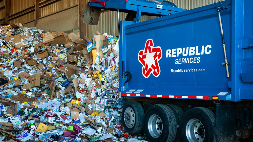 A truck unloading mixed recyclables to a facility A truck unloading mixed recyclables to a facility