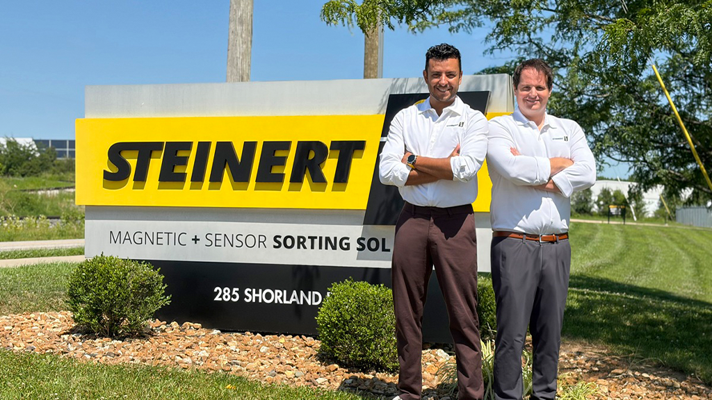 Two men stand next to an outdoor STEINERT sign Two men stand next to an outdoor STEINERT sign