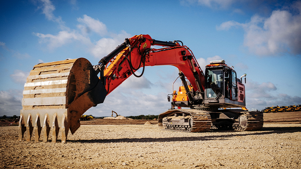An orange excavator fitted with a bucket attachment An orange excavator fitted with a bucket attachment