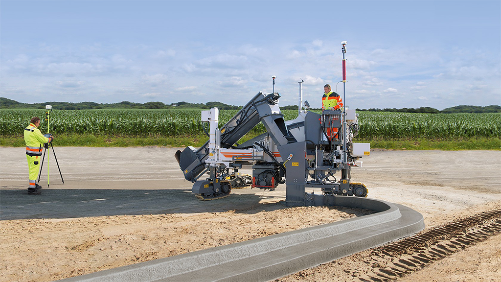 Two men working next to a paver Two men working next to a paver