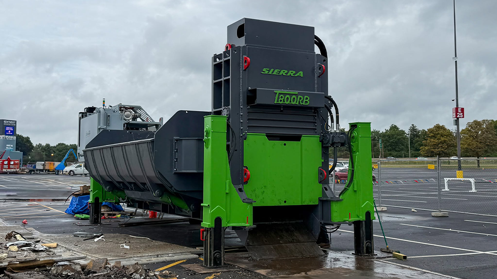 The side of a large green car baler