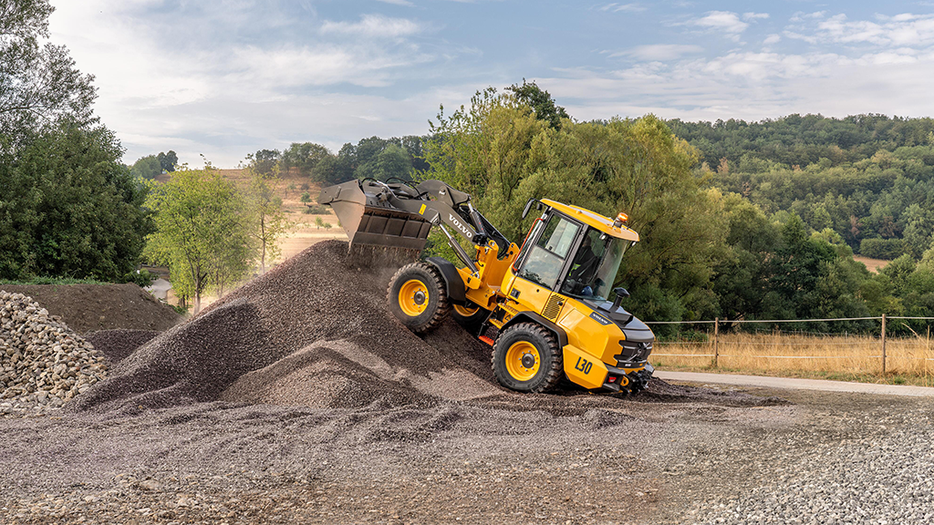 A wheel loader drives on a pile of aggregates A wheel loader drives on a pile of aggregates