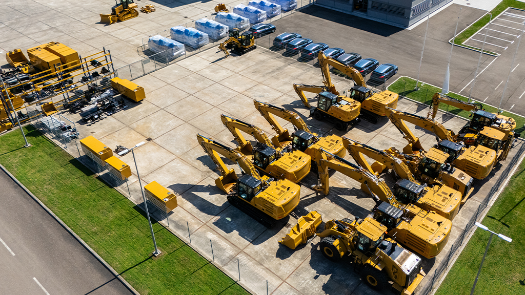 An aerial view of a heavy equipment yard with various machines An aerial view of a heavy equipment yard with various machines
