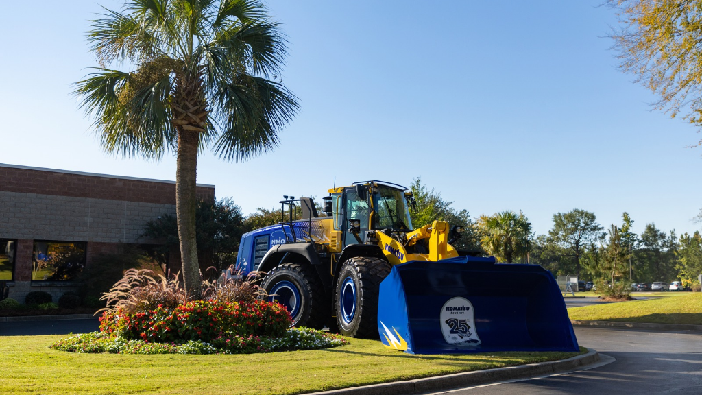 A wheel loader parked in front of a manufacturing facility A wheel loader parked in front of a manufacturing facility