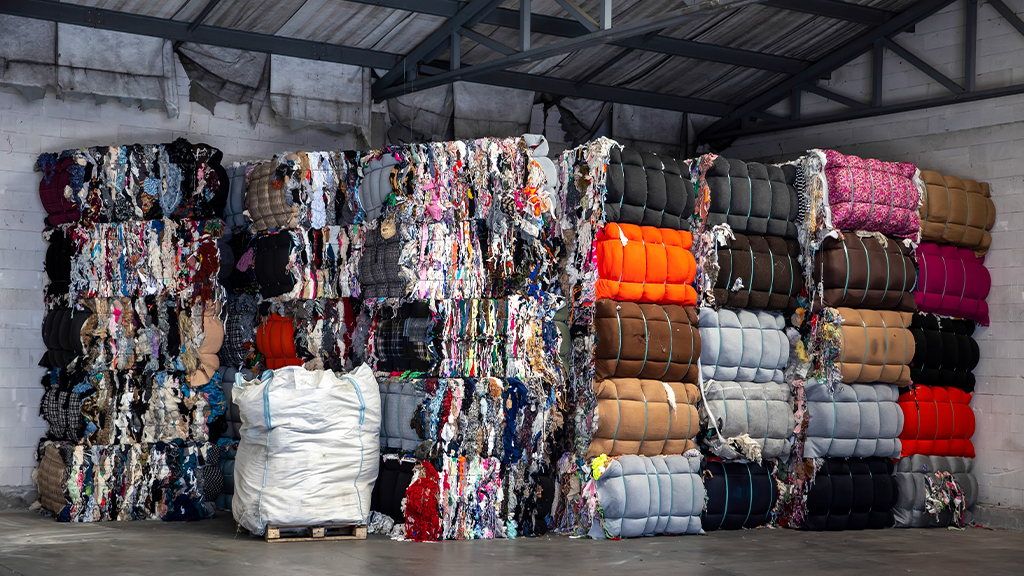Large bales of textiles and clothing in a warehouse Large bales of textiles and clothing in a warehouse