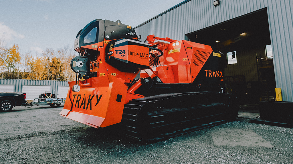 A large orange tracked tool carrier